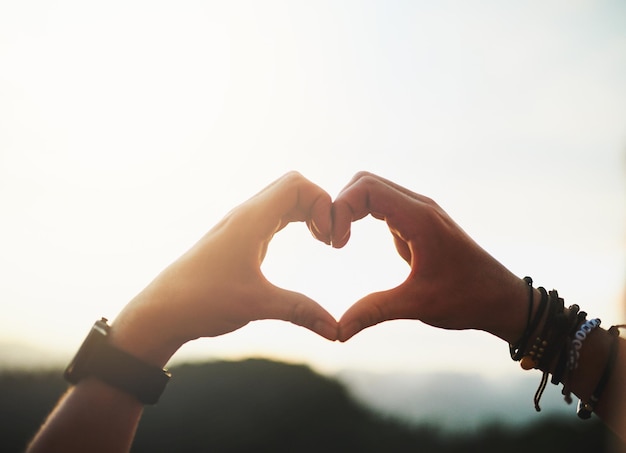 I heart nature Closeup shot of an unidentifiable man making a heart shape with his hands outside