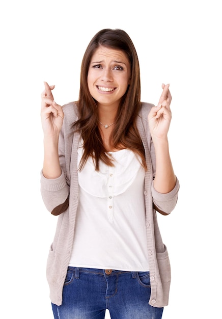 I hope everything turns out ok Casually dressed young woman with her fingers crossed against a white background