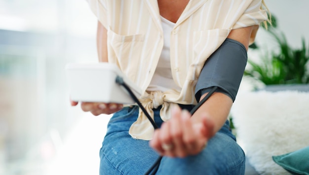 i hope my blood pressure came down cropped shot of a woman checking her blood pressure at home