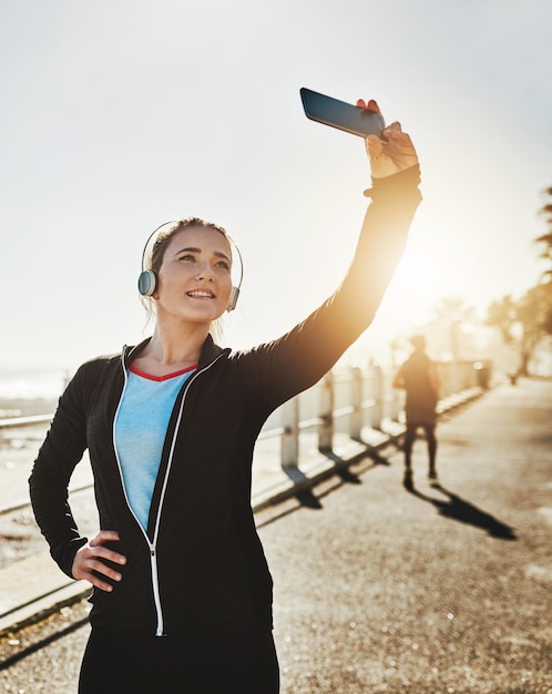 I inspire others to live healthy too Cropped shot of a sporty young woman taking a selfie while out on the promenade