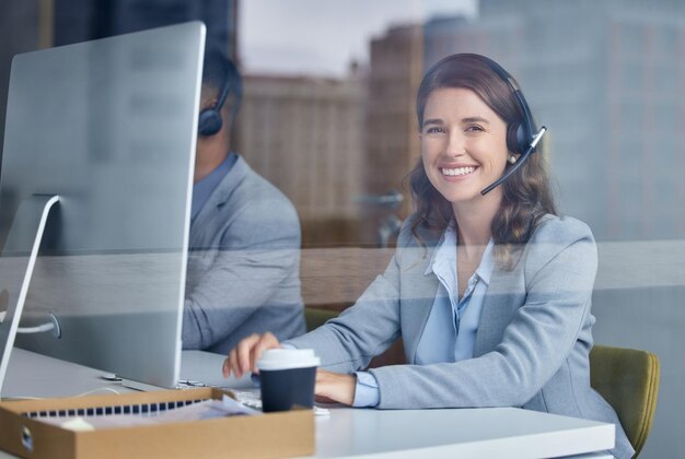 I live to help people Cropped portrait of an attractive young female call center agent working at her desk