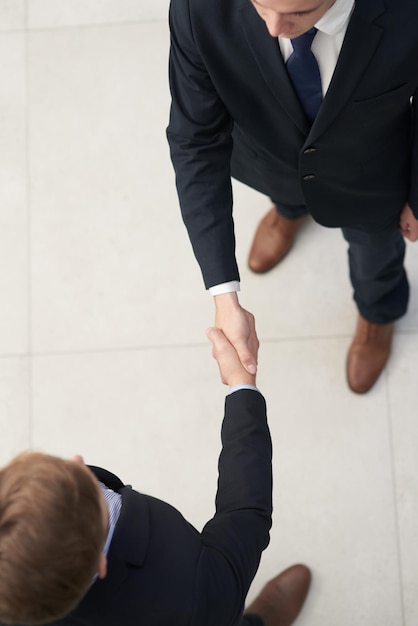 I look forward to collaborating together Shot of two businesspeople shaking hands in an office