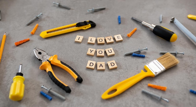 I love dad message with tools for repair saw nippers hammer top\
view flat lay father\'s day concept