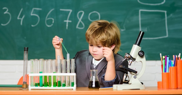 I love my job testing tubes with liquid for research result Medical concept Little genius child learn for future Biology science small boy study chemistry small boy using microscope at lesson