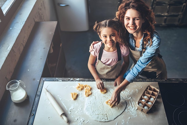 I love my mom attractive young woman with little cute girl are spending time together at home happy family concept mother's day