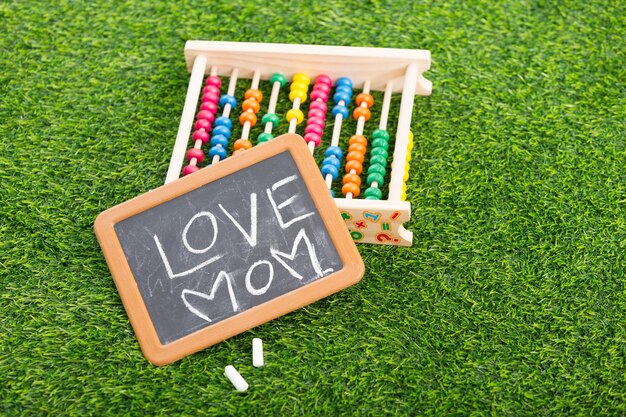 I love my mom and mother day phrase handwritten on the school blackboards on wood background