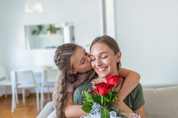 i love my you mom attractive young woman with little cute girl are spending time together at home thanking for handmade card with love symbol and flowers happy family concept mothers day