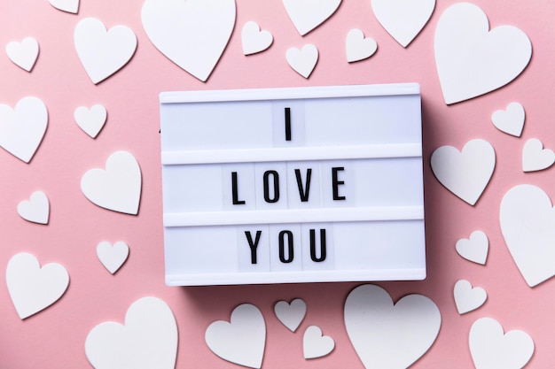 I love you lightbox message with white hearts on a pink\
background