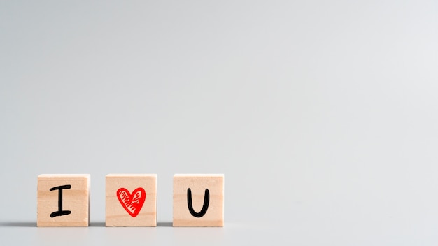 " I LOVE YOU " lovely hand drawn letter and heart symbol on wood cube, concept for Valentine's day