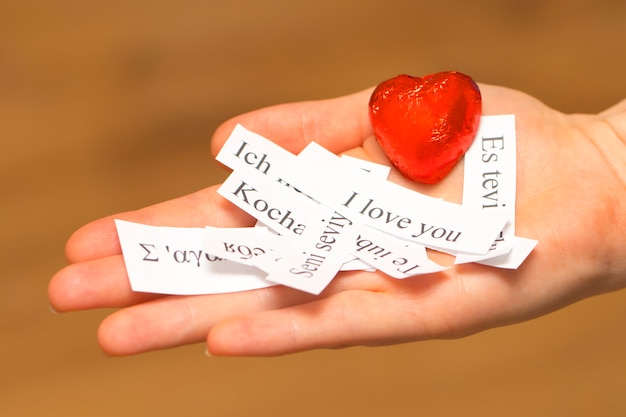 Photo i love you. the words, printed on papers in different languages on your palm