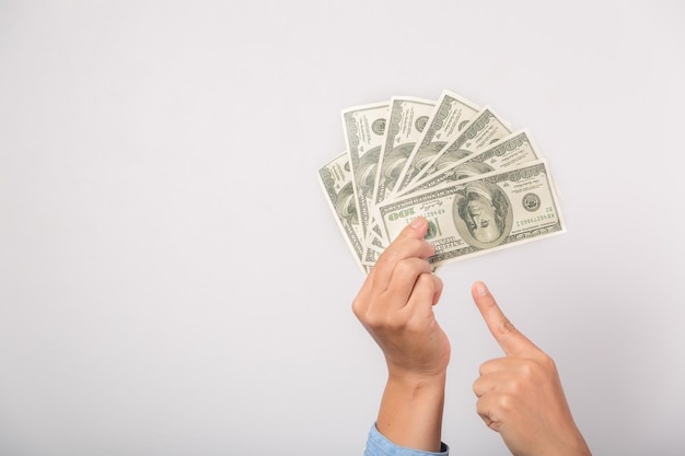 I'm rich Portrait of successful happy woman with fancy brown hair pointing to dollar bills showing money and boasting lottery winning big profit