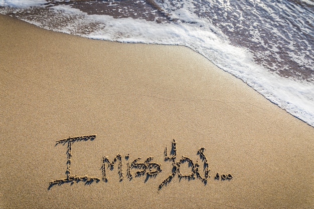 I miss you. Loving lack written on sand