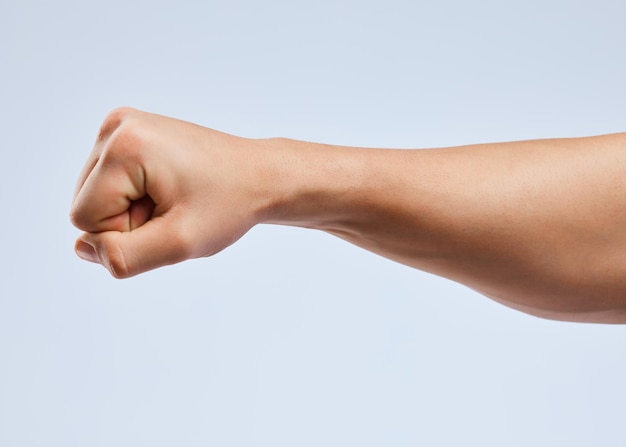 I ought to punch you in the throat Shot of an unrecognizable man holding his fist up against a white background