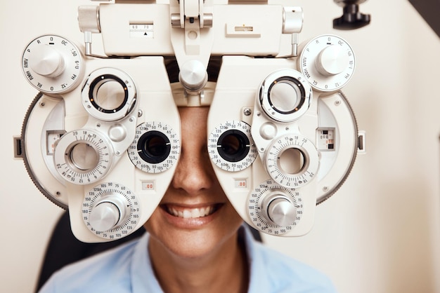 I spy with my little eye Shot of a young woman getting her eyes examined with an optical refractor