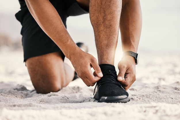 I talk the talk and I run the run. Cropped shot of an unrecognizable man tying his shoelaces while out for a workout.