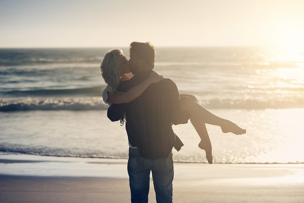 I waited for someone like you all my life Shot of a loving couple sharing a kiss while spending time at the beach