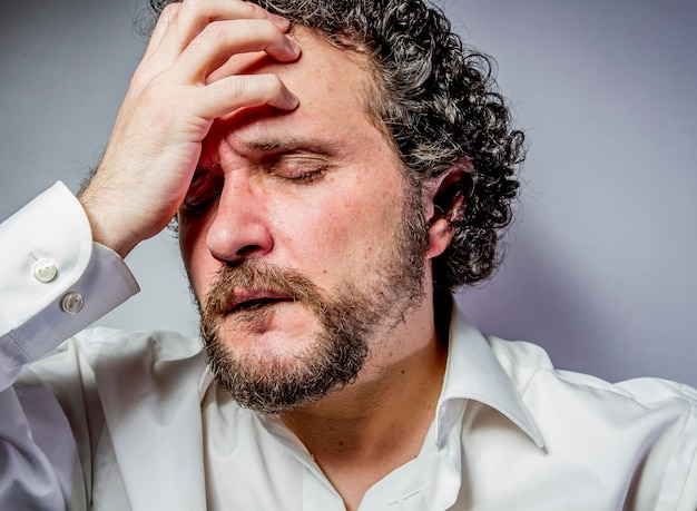 I do not want to hear anything, man with intense expression, white shirt