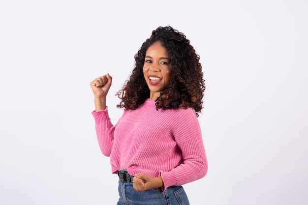 I won Black woman celebrating on white background