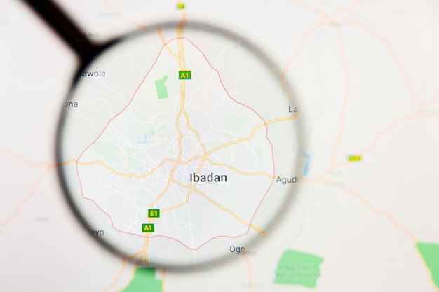 Ibadan, nigeria city visualization illustrative concept on\
display screen through magnifying glass