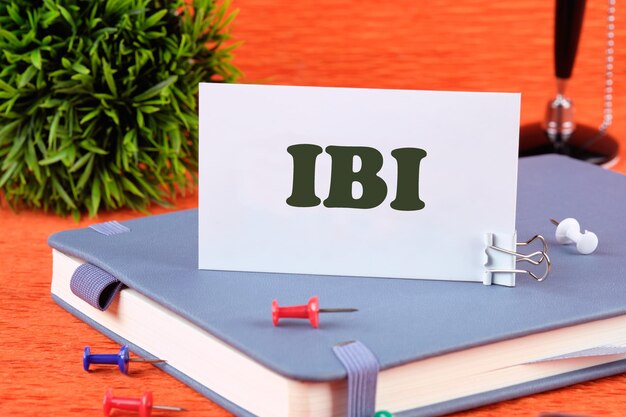 Photo ibi symbol on a white business card standing on a notepad