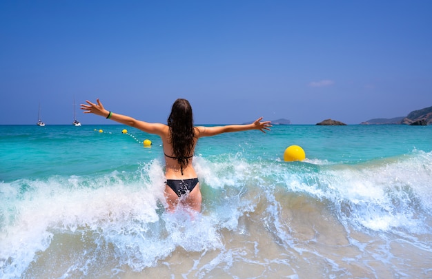 Ibiza beach girl splashing water in Balearics