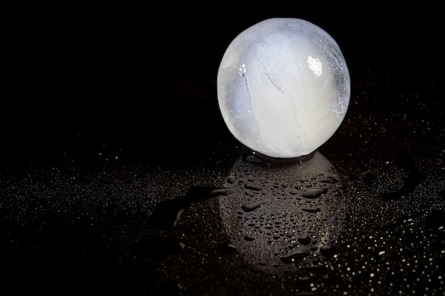 Ice ball reflection on black background.