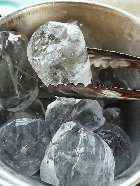 Ice bucket with hand holding tongs