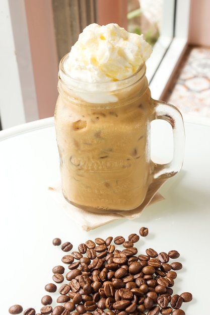 Ice cappuccino served with milk foam.