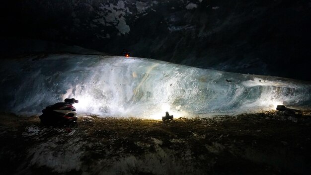 In an ice cave with colored lighting from lanterns