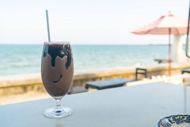 Ice chocolate milkshake with sea background