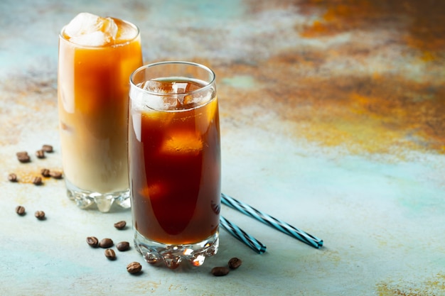 Ice coffee in a tall glass with cream