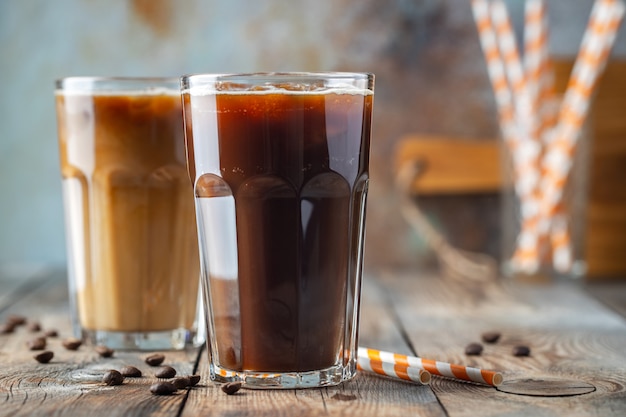 Ice coffee in a tall glass with cream.