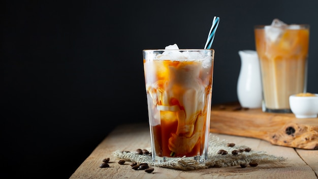 Ice coffee in a tall glass with cream.