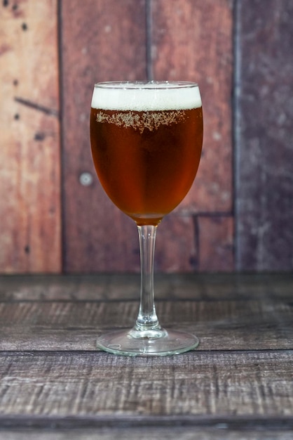 Ice cold beer glass on wooden background Copy space