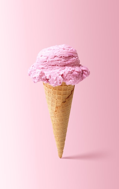 ice cream cone closeup pink icecream scoop in waffle cone over pink background