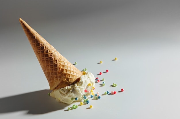 Ice cream cone fallen on white background.