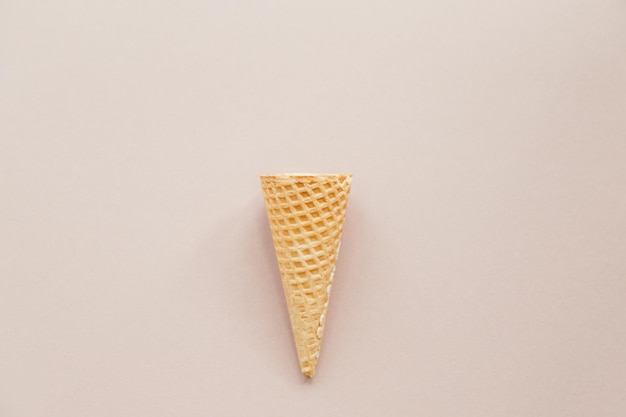 Ice cream cone on pastel pink background minimal summer concept\
flat lay