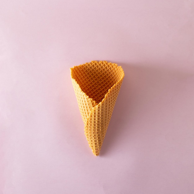 Ice cream cone on purple pastel background Minimal summer concept Flat lay