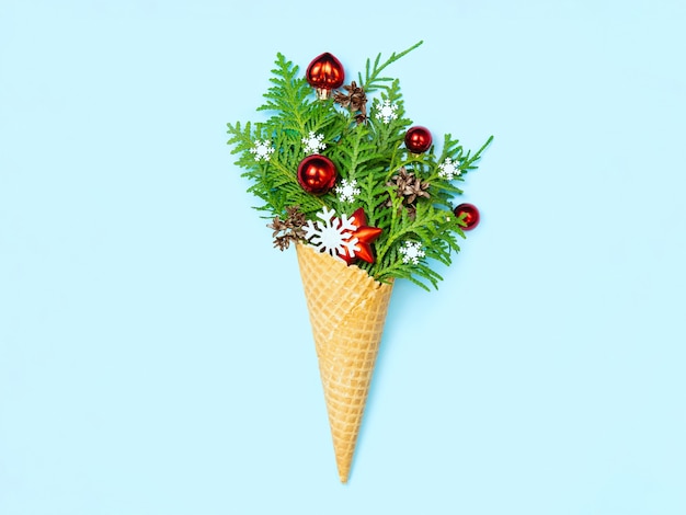 Ice cream cone with thuja sprigs and Christmas toys.