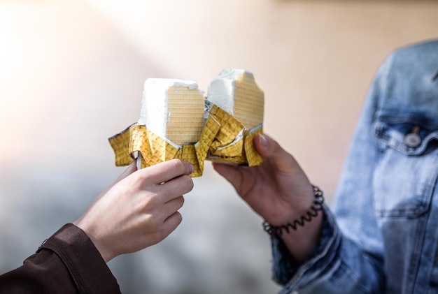 Ice cream in the hands of two girls Closeup