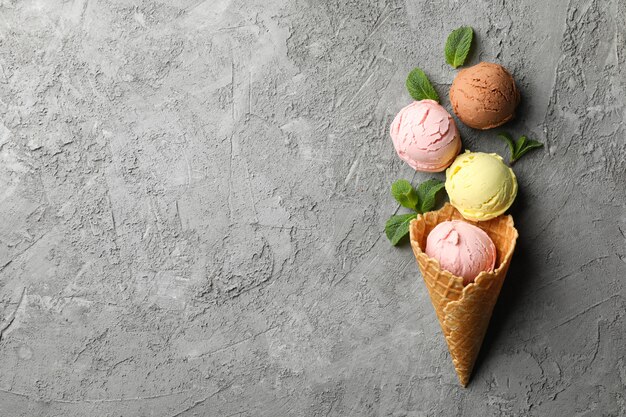 Ice cream and mint on grey surface