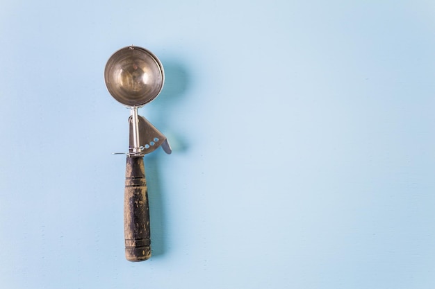 Ice cream scoop on a blue background.