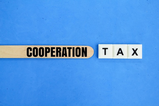 ice cream sticks and letters of the alphabet with the word Cooperation tax tax concept for the corp