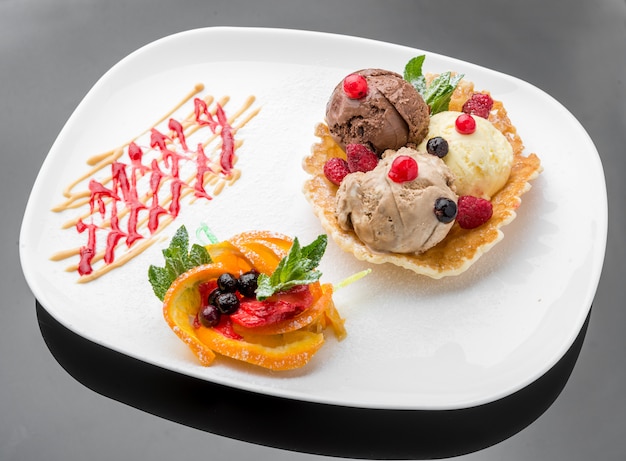 Ice cream sundae, waffle cone and sliced strawberry