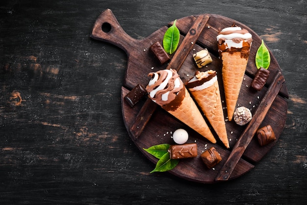 Ice cream in a waffle cup on a black background Top view Free copy space