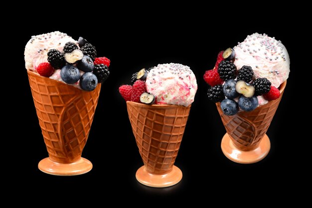 Ice cream with blueberries, blackberries and raspberries on a black wall.  Copy space.