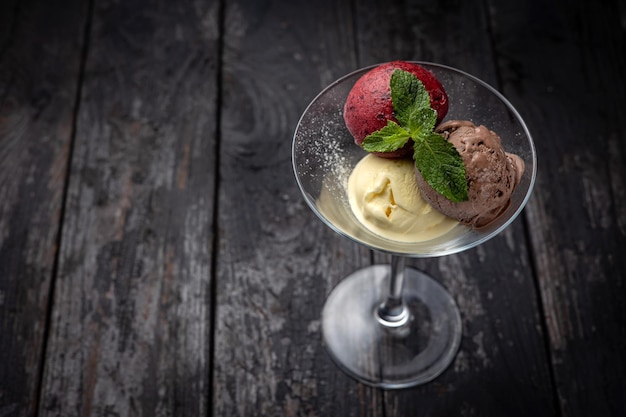 Ice cream with mint on a dark background.