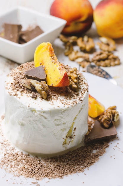 Ice cream with peach, chocolate and nuts.