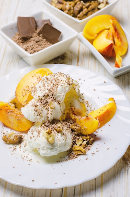 Ice cream with peach, chocolate and nuts