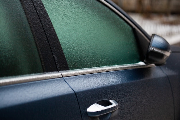 Ice crust on the car headlight after ice rain